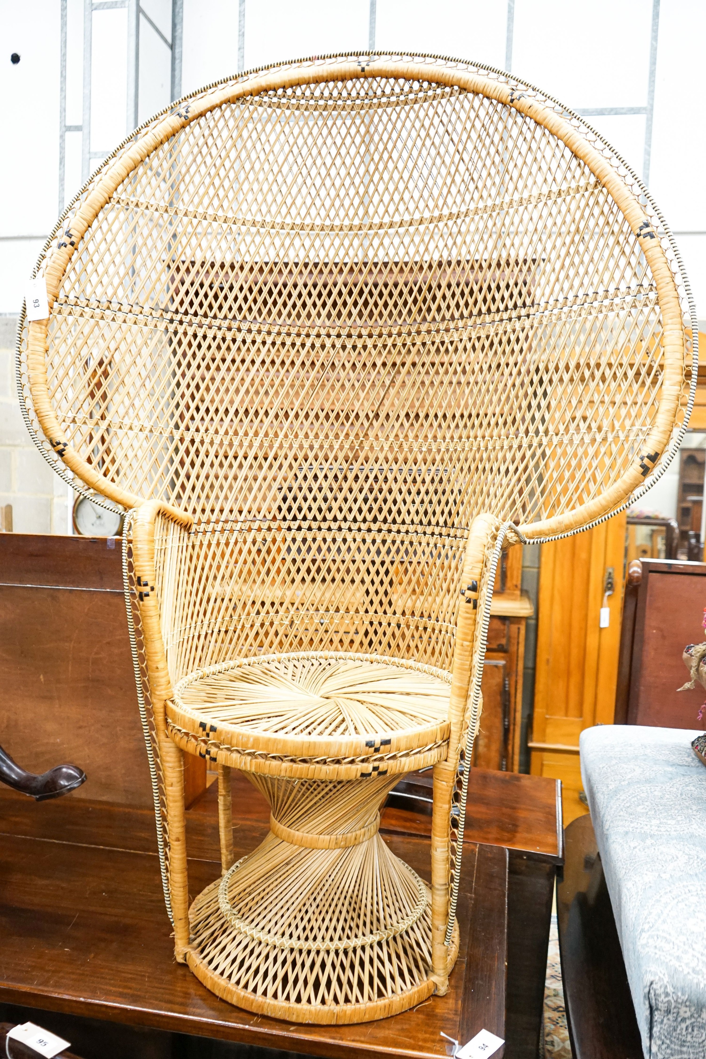 A caned 'peacock' chair, width 107cm, height 150cm